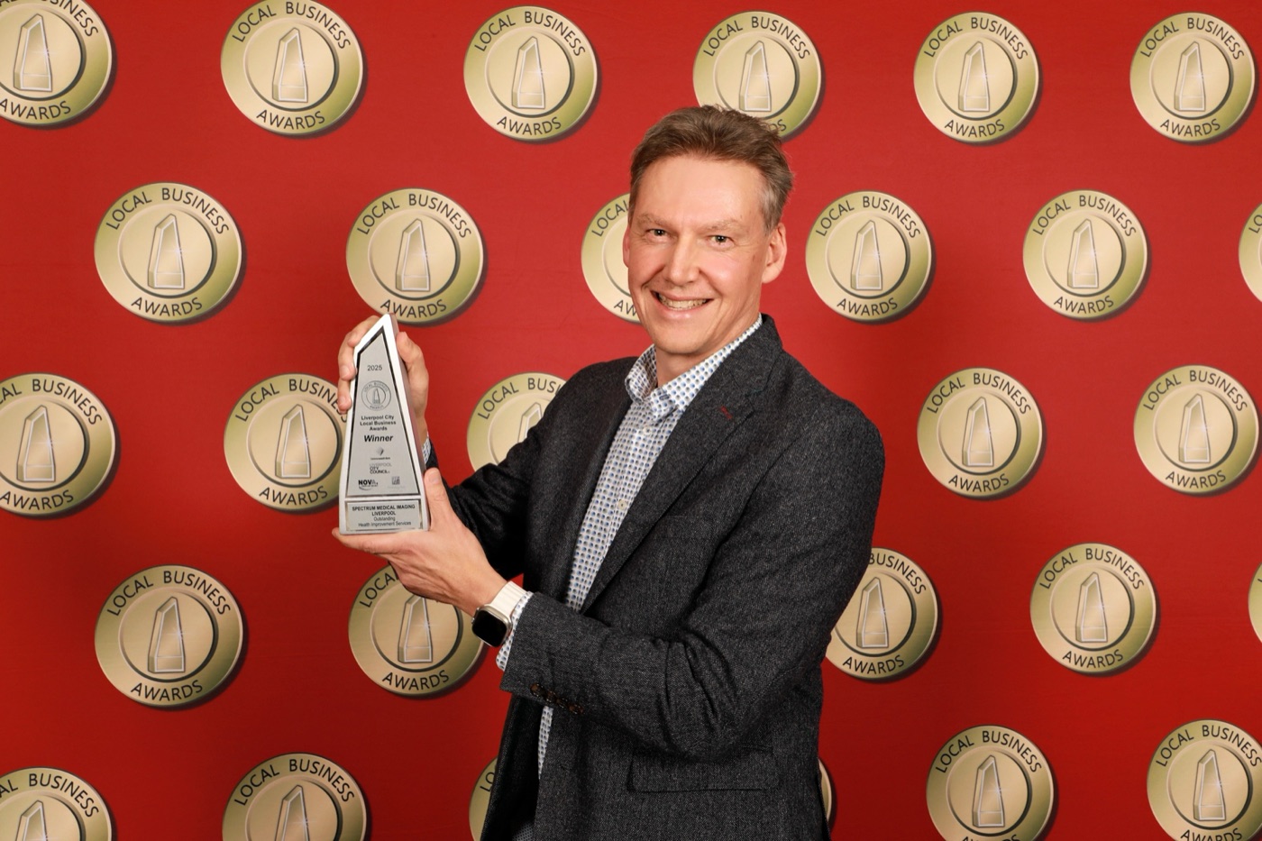 Dr Glen Schlaphoff holding the 2025 Liverpool City Local Business Awards trophy