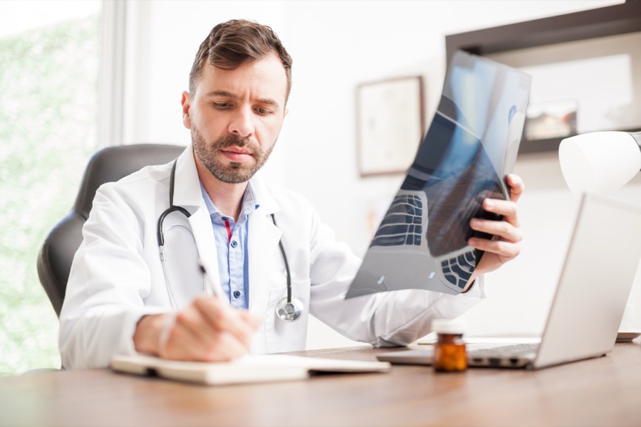 A doctor reviewing X-ray images