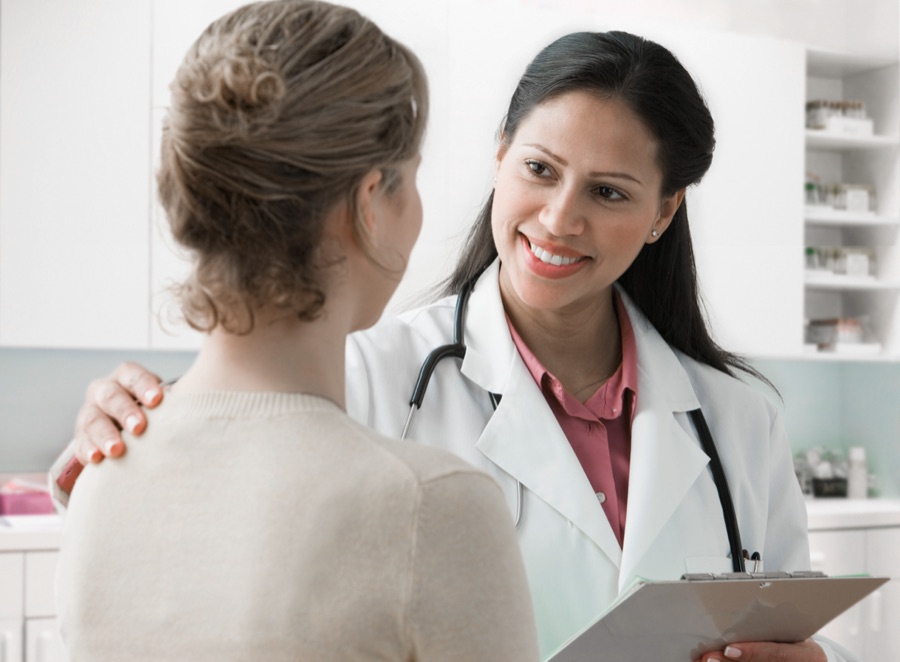 A Spectrum staff member with a patient